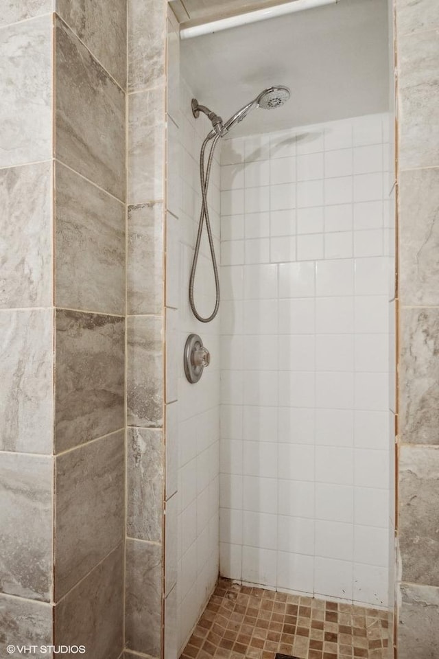 bathroom with tiled shower