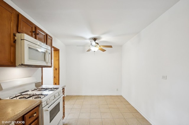 kitchen with white appliances, ceiling fan, and light tile patterned flooring