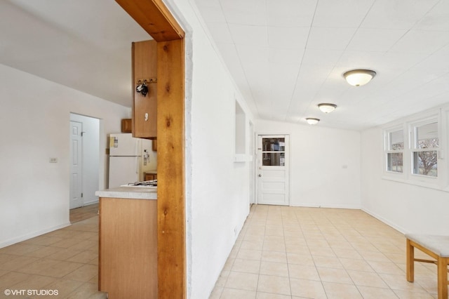 corridor with light tile patterned floors