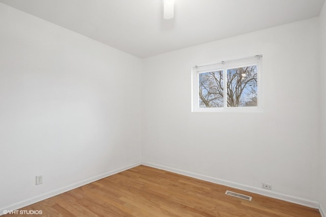 spare room featuring hardwood / wood-style flooring