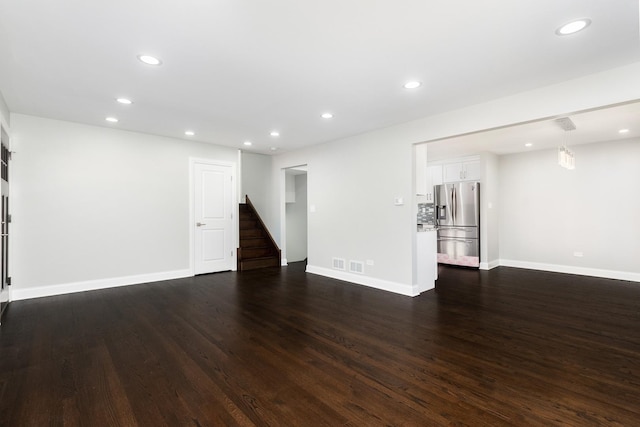 unfurnished living room with dark hardwood / wood-style flooring