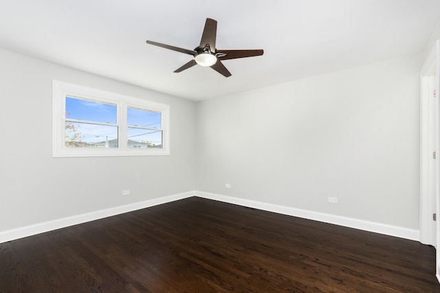 empty room featuring ceiling fan and dark hardwood / wood-style flooring