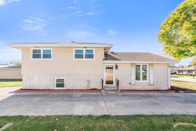 tri-level home featuring a patio area