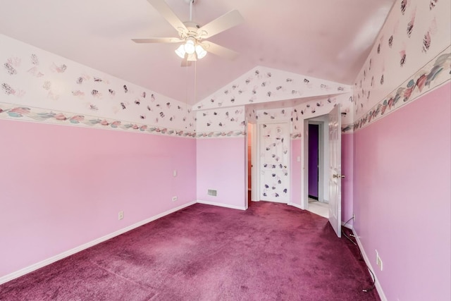 unfurnished bedroom with lofted ceiling, visible vents, baseboards, and carpet flooring