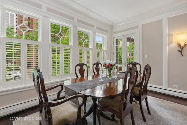 sunroom featuring a baseboard heating unit and french doors