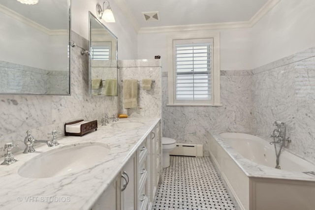 bathroom featuring crown molding, a wealth of natural light, a bathtub, and a baseboard radiator