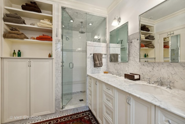 bathroom featuring an enclosed shower, vanity, crown molding, and backsplash