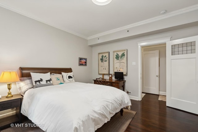 bedroom with dark hardwood / wood-style flooring and crown molding