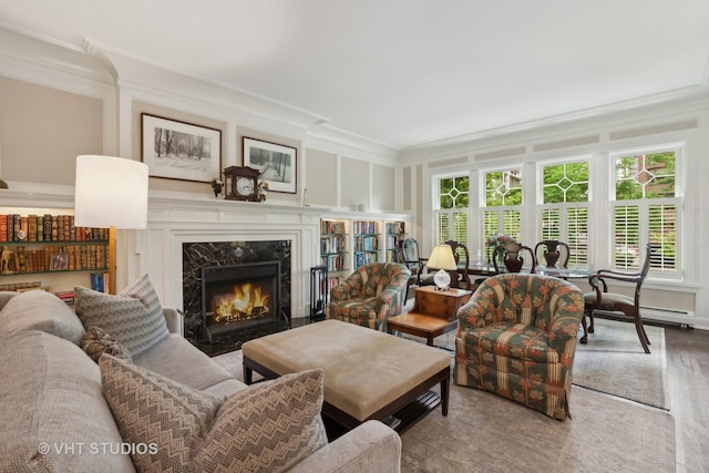 living room featuring ornamental molding and a premium fireplace