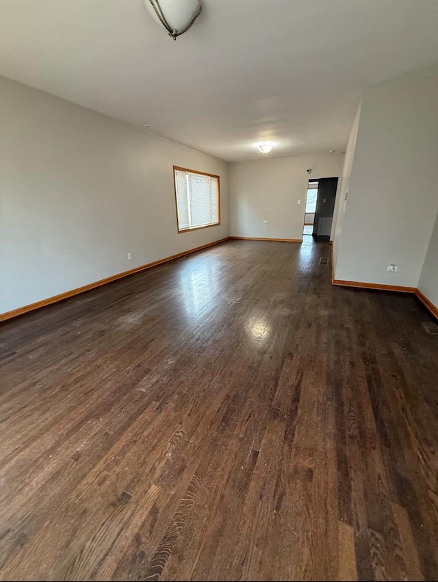 unfurnished room featuring dark hardwood / wood-style flooring