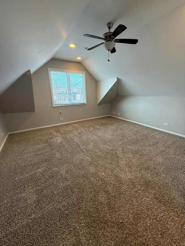 bonus room with vaulted ceiling and carpet