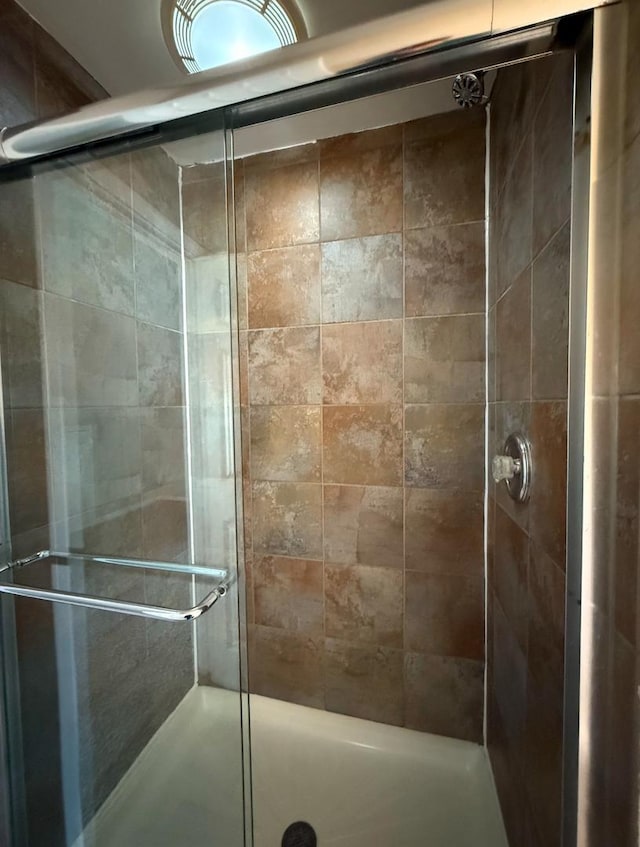 bathroom with a shower with shower door