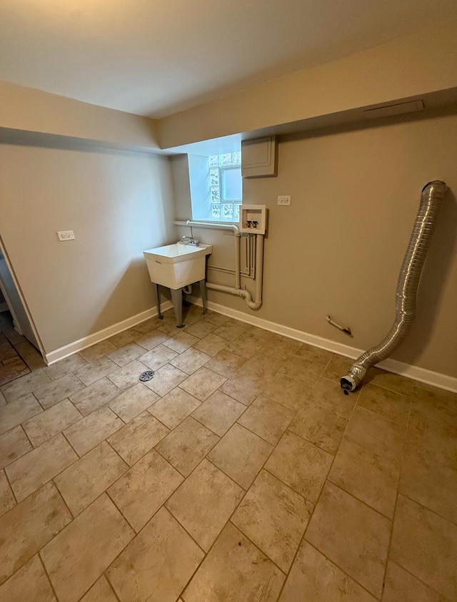 clothes washing area featuring light tile patterned flooring, sink, and hookup for a washing machine