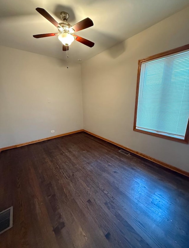 empty room featuring ceiling fan and dark hardwood / wood-style flooring