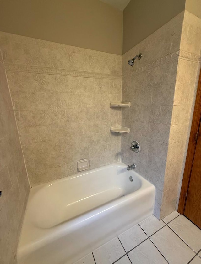 bathroom with tiled shower / bath combo and tile patterned floors