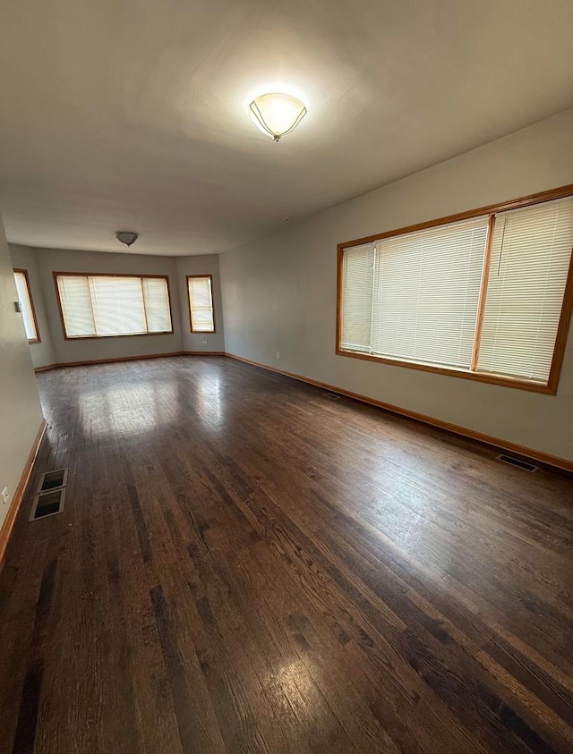 empty room with dark hardwood / wood-style floors