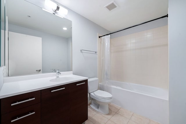 bathroom featuring toilet, vanity, visible vents, tile patterned floors, and shower / bath combo with shower curtain