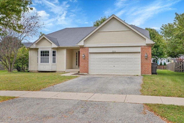 ranch-style house with a garage and a front lawn