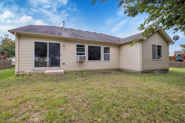 rear view of house featuring a yard and cooling unit