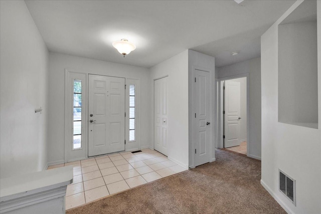 view of carpeted entrance foyer