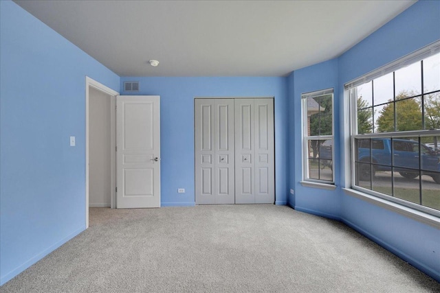 unfurnished bedroom with carpet floors and a closet