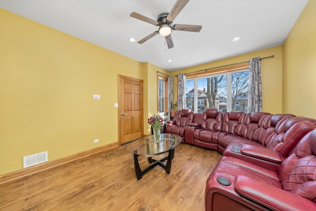 living room featuring ceiling fan and light wood-type flooring