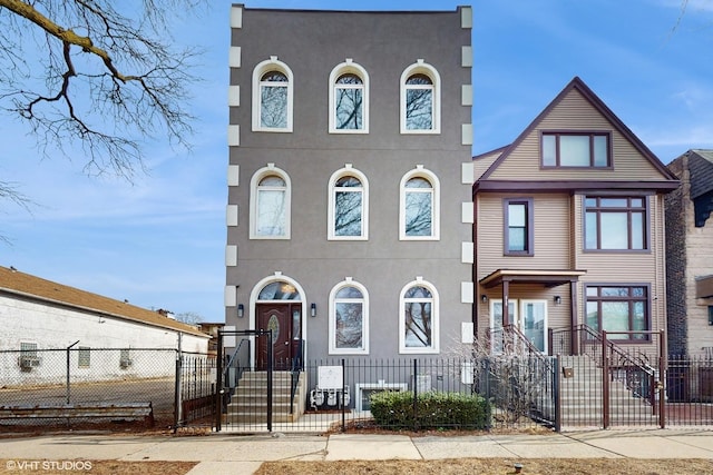 view of front of house with a fenced front yard and stucco siding