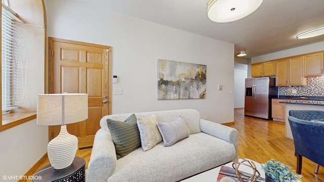 living area with light wood-style floors and baseboards