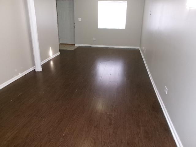 empty room with dark wood-type flooring