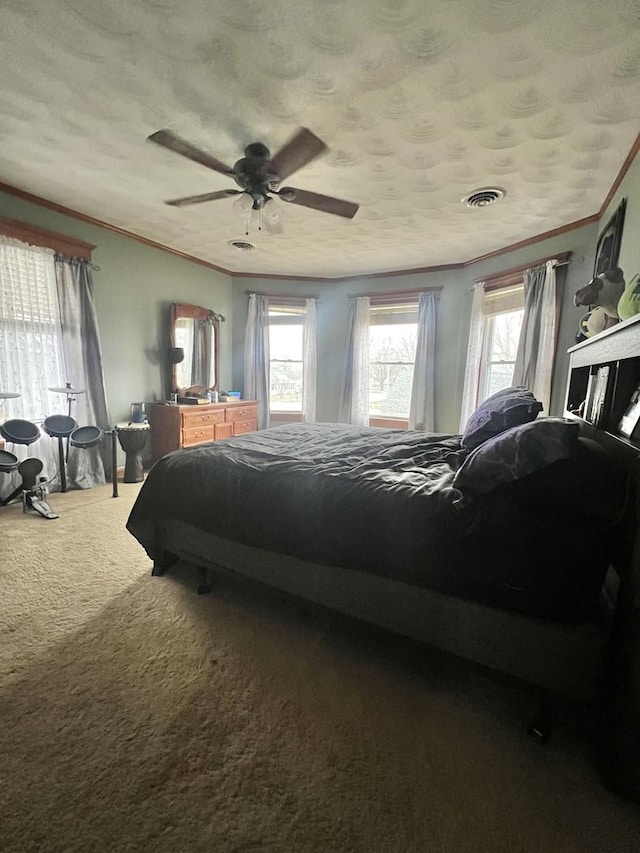 bedroom featuring crown molding, ceiling fan, and dark colored carpet