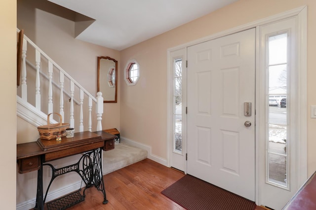 foyer entrance with plenty of natural light and wood-type flooring