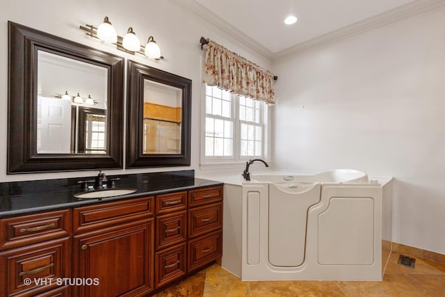 full bathroom with visible vents, ornamental molding, a bath, and vanity