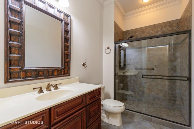 bathroom featuring a stall shower, vanity, toilet, and crown molding