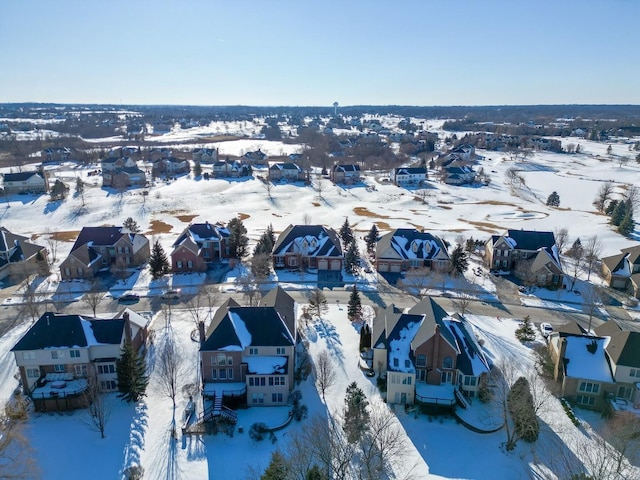 snowy aerial view with a residential view