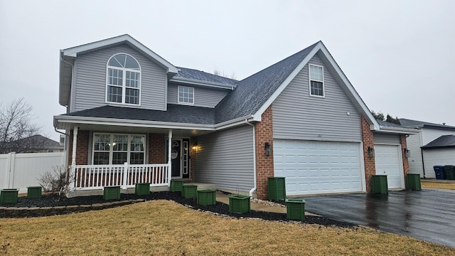 front facade featuring a front yard, covered porch, and central air condition unit