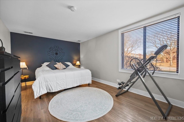 bedroom with dark wood-type flooring