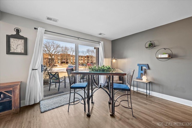 dining area with hardwood / wood-style flooring