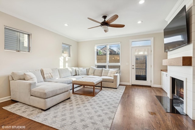 living room featuring ornamental molding, dark hardwood / wood-style floors, and ceiling fan