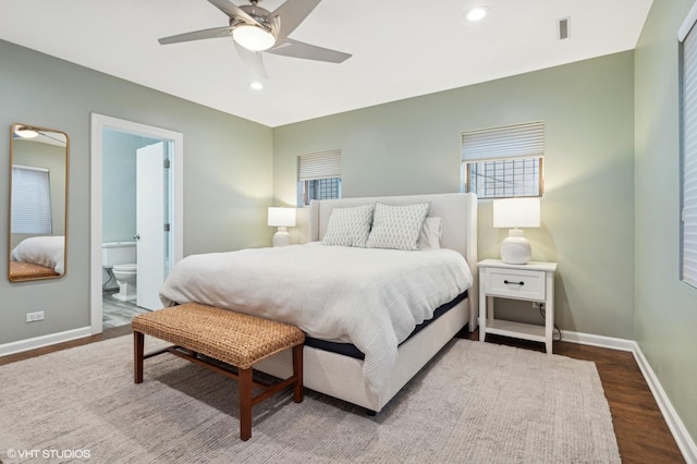 bedroom with wood-type flooring, connected bathroom, and ceiling fan