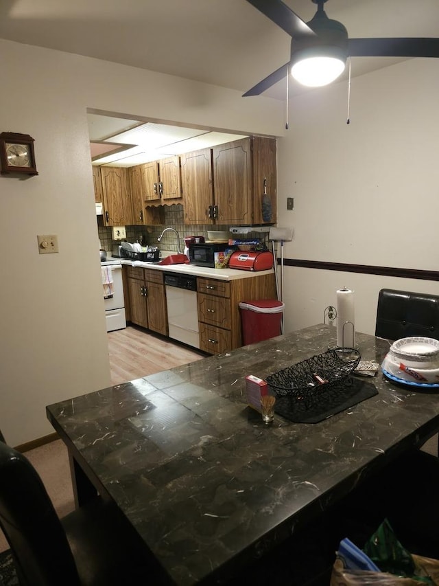 kitchen with ceiling fan, sink, white appliances, and decorative backsplash