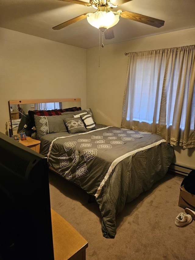 carpeted bedroom featuring ceiling fan and baseboard heating