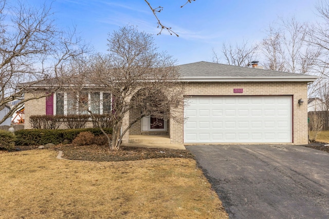 ranch-style house with driveway, an attached garage, and brick siding