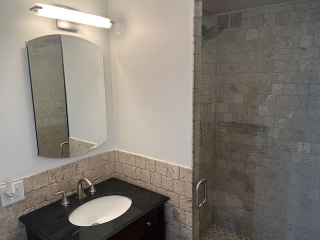 bathroom featuring vanity and a shower with shower door