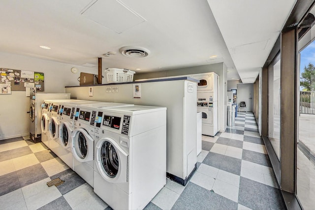 clothes washing area featuring stacked washer / drying machine and washer and clothes dryer