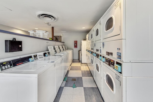 laundry room with stacked washing maching and dryer and washer and clothes dryer