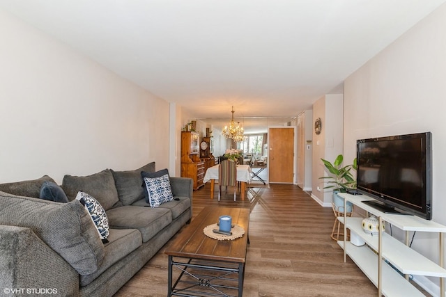 living room with a notable chandelier and wood-type flooring