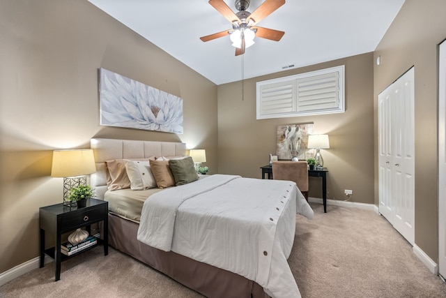 bedroom featuring ceiling fan, light colored carpet, and a closet