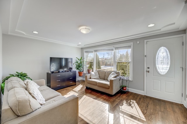 living room featuring baseboards, wood finished floors, and recessed lighting