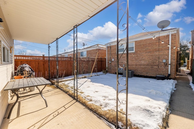 snow covered patio with fence