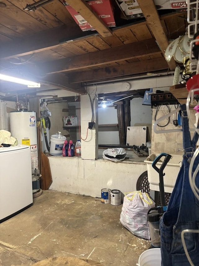 basement featuring refrigerator and water heater